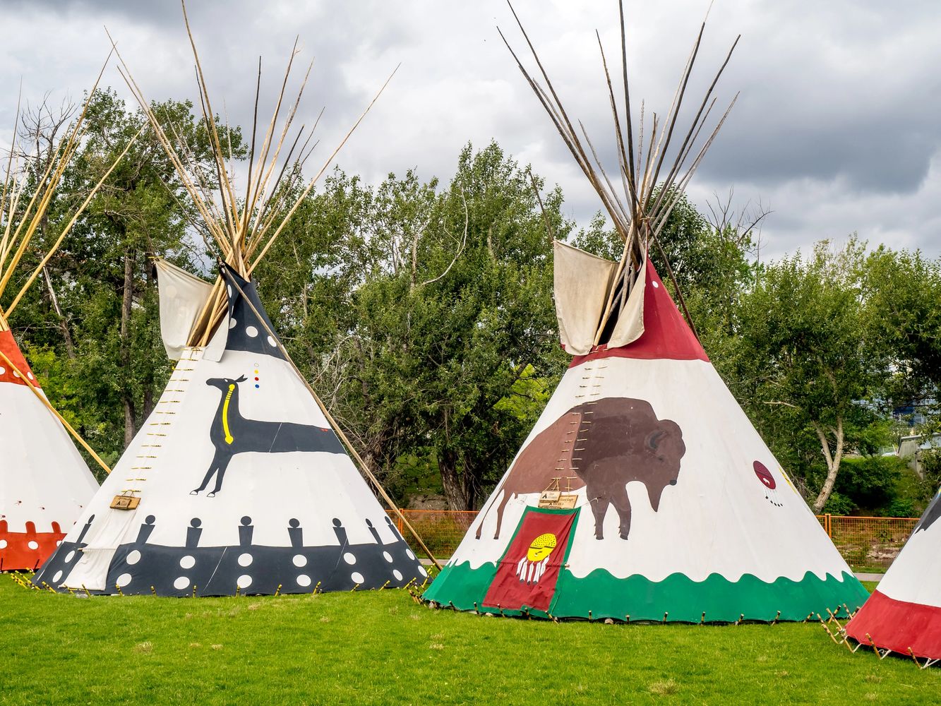 Traditional decorated tipis representing community and learning